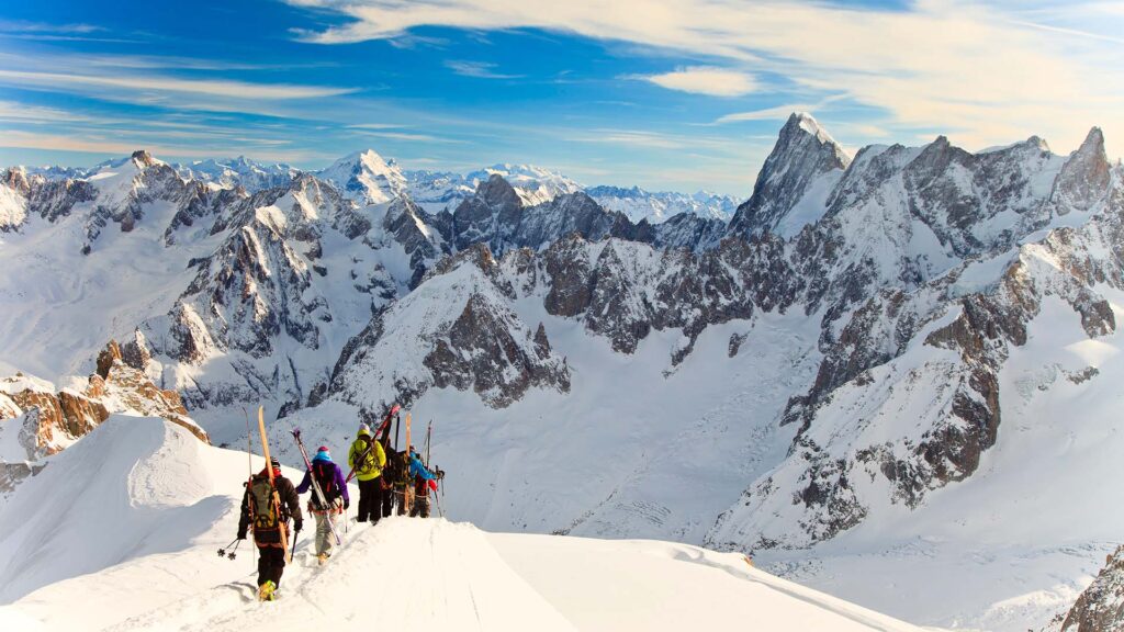 a group of people trekking through the snow in Chamonix, France